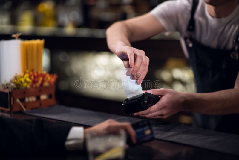 The Bartender Accepts Payment by Credit Card at the Bar Stock Photo
