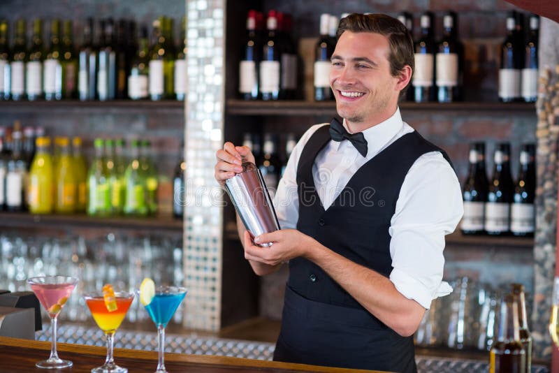 Bartender Mixing a Cocktail Drink in Cocktail Shaker Stock Image