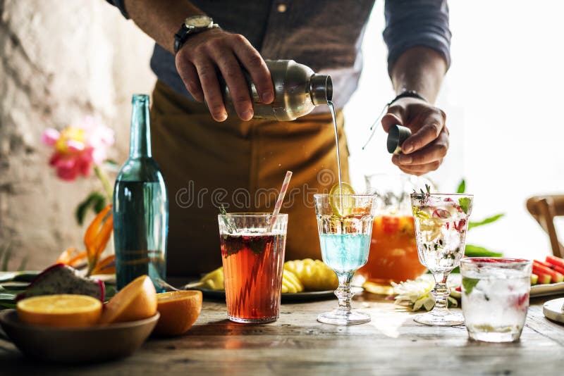 Bartender mixing colorful cocktails