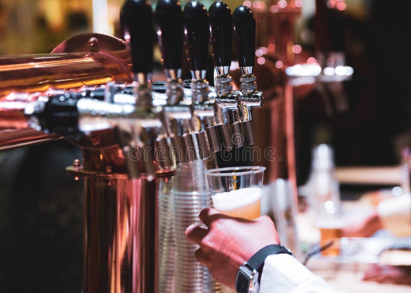 Bartender Pouring Draft Beer in the Bar, Barman Hand at Beer Tap