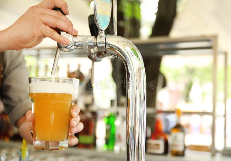 Bartender pouring fresh cold beer from tap, stock photo Bartender pouring fresh cold beer from tap, stock photo