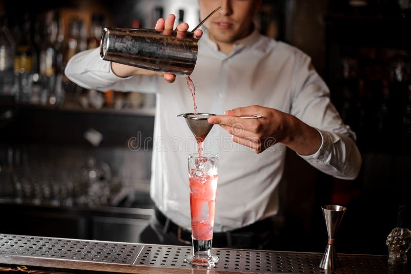 https://thumbs.dreamstime.com/b/bartender-pouring-red-alcoholic-drink-steel-shaker-bartender-pourring-transparent-red-alcoholic-drink-steel-118680661.jpg