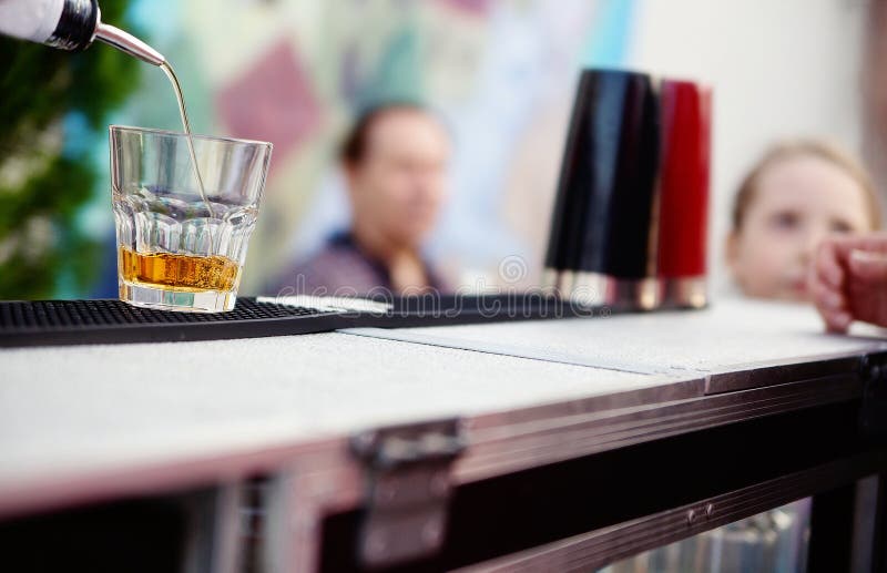 Bartender pouring whiskey into a glass royalty free stock photos Bartender pouring whiskey into a glass royalty free stock photos