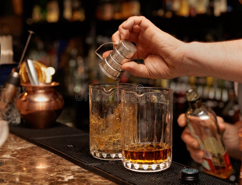 Bartender is pouring whisky in glass royalty free stock images Bartender is pouring whisky in glass royalty free stock images