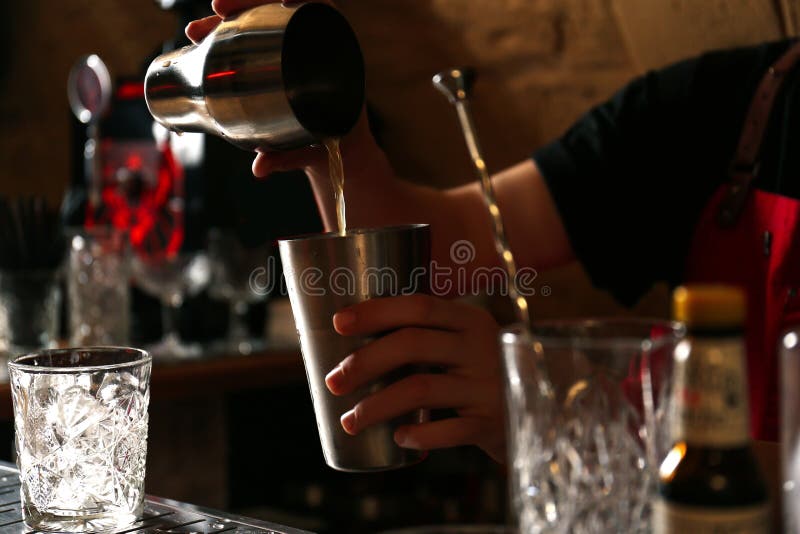 Bartender preparing alcoholic cocktail at bar counter, closeup royalty free stock photos Bartender preparing alcoholic cocktail at bar counter, closeup royalty free stock photos