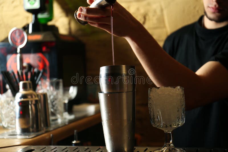 Bartender preparing fresh alcoholic cocktail at bar counter stock images Bartender preparing fresh alcoholic cocktail at bar counter stock images
