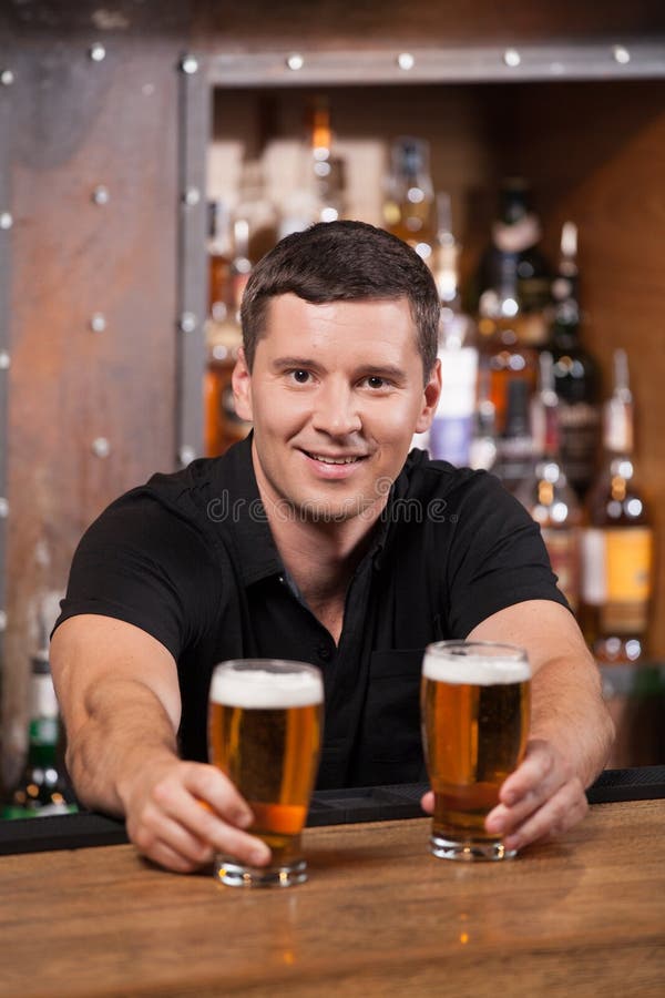 Bartender Serving Two Glasses of Beer. Stock Image Image of alcoholic, hospitality 44422683