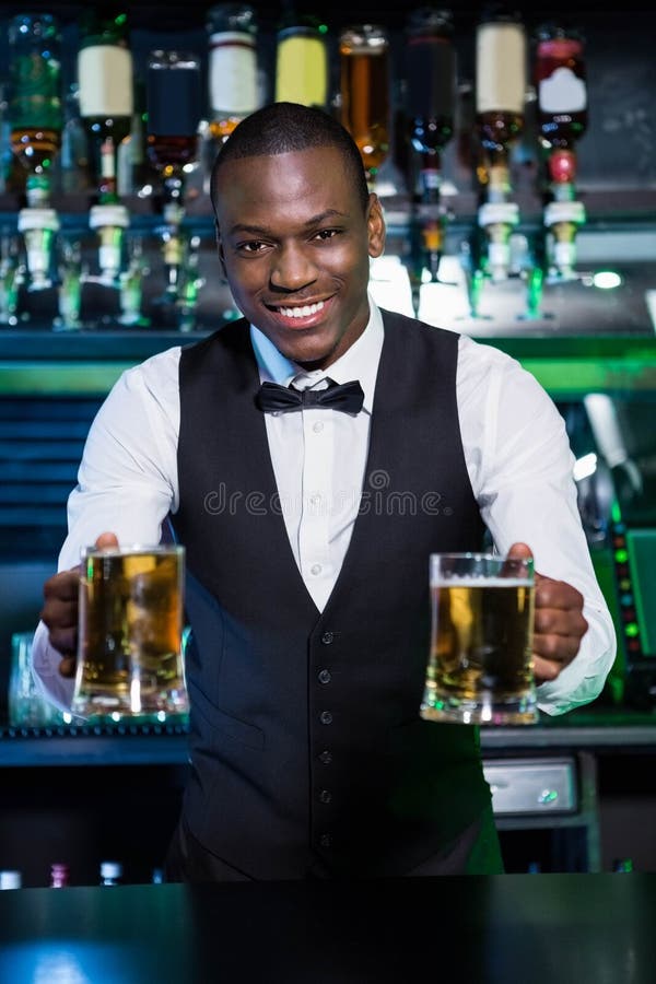 Bartender Serving Two Glasses of Beer Stock Image Image of holding, camera 67545577