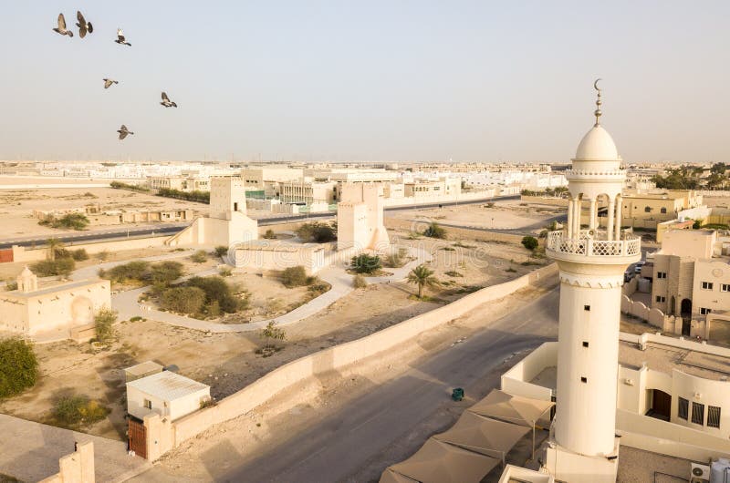 Barzan old watchtowers and a modern mosque. Old Ancient Arabian fortification, Qatar. Middle East. Persian Gulf. stock images Barzan old watchtowers and a modern mosque. Old Ancient Arabian fortification, Qatar. Middle East. Persian Gulf. stock images