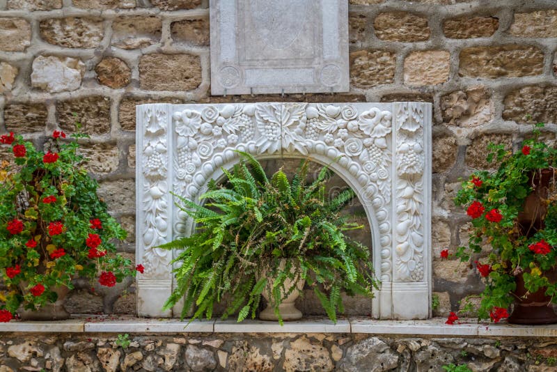 Bas-relief and flowers, courtyard of the Greek Orthodox Wedding Church in Cana, Israel.