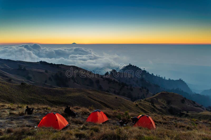 Base Camp at Mt. Rinjani volcano at Lombok island, Indonesia at sunset, far away is Mt. Agung volcano at Bali island royalty free stock images Base Camp at Mt. Rinjani volcano at Lombok island, Indonesia at sunset, far away is Mt. Agung volcano at Bali island royalty free stock images