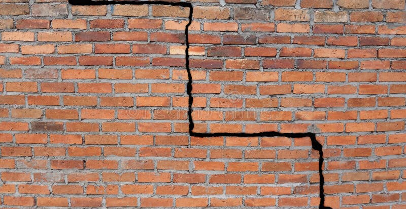 Large crack in a brick wall building foundation. Large crack in a brick wall building foundation