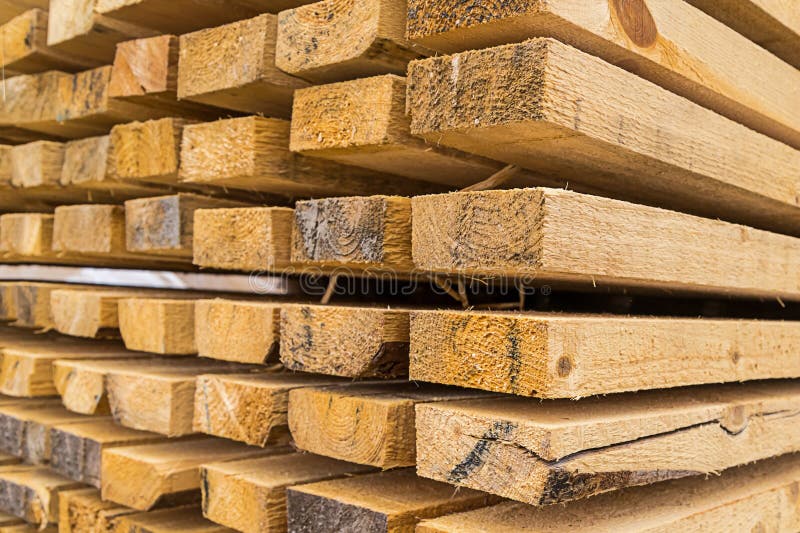 Base wooden long boards high stack building materials background natural rustic focus on the front row royalty free stock photo