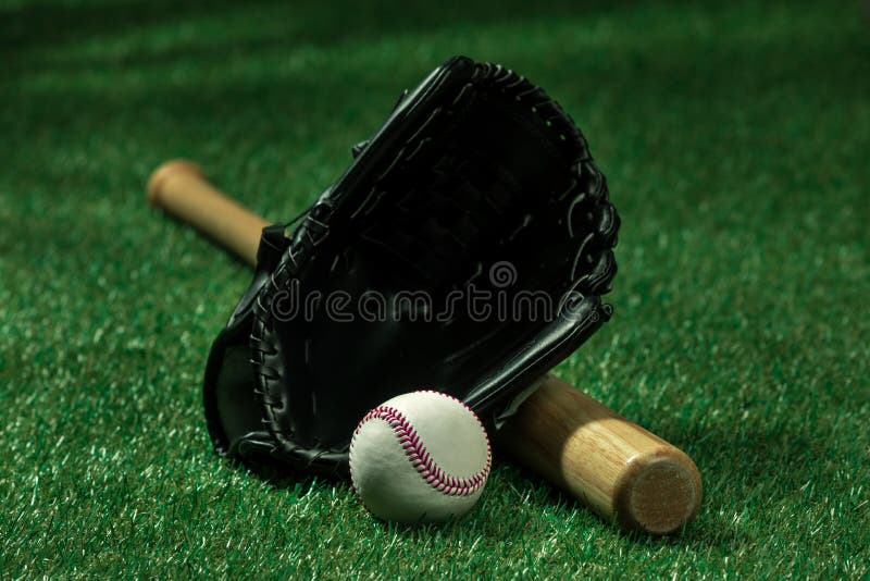 Baseball Bat, Glove and Ball Lying on Green Grass Stock Photo Image