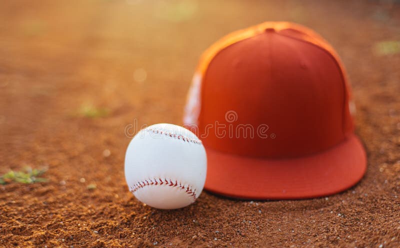 Baseball cap and ball on pitchers mound. Baseball cap and ball on pitchers mound.