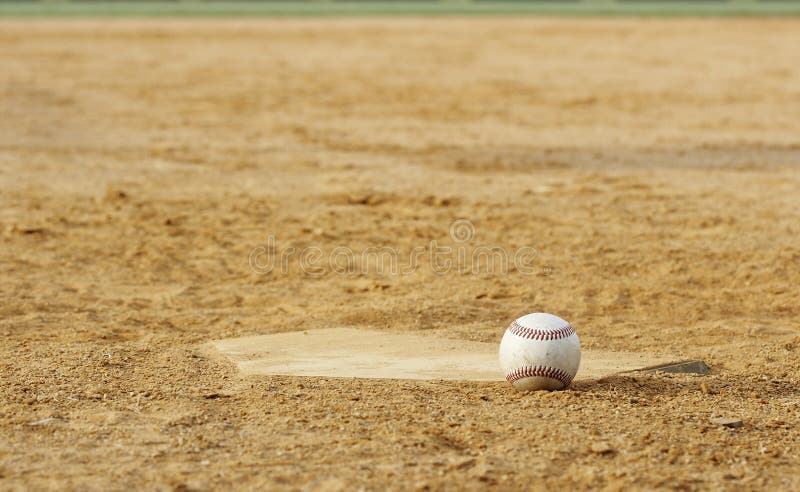 One baseball on infield of sport field. One baseball on infield of sport field