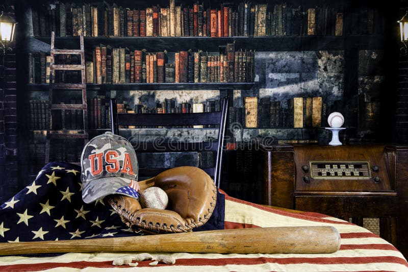 Baseball glove and bat on American flag in old library royalty free stock photography