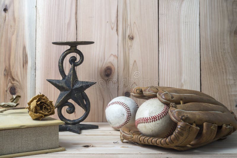 Baseball and glove on wooden