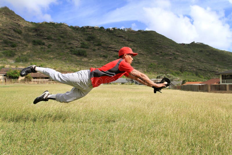 Baseball Player Jumps To Catch a Fly Ball Stock Photo Image of field
