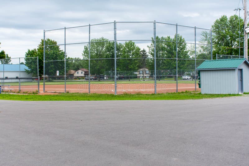 Baseball or softball diamond through a fence in park in a small town Canadian city of Brighton near Pesquile Lake Provincial Park stock photography Baseball or softball diamond through a fence in park in a small town Canadian city of Brighton near Pesquile Lake Provincial Park stock photography