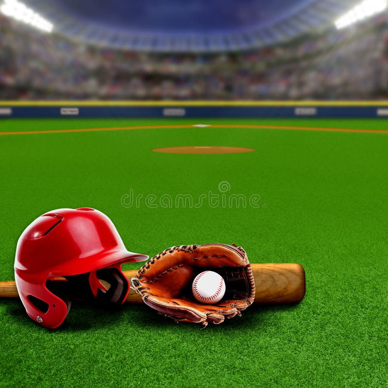 Baseball stadium full of fans in the stands with baseball helmet, bat, glove and ball on the field. Deliberate focus on equipment and foreground with shallow depth of field on background. Floodlights flare for effect and copy space. Baseball stadium full of fans in the stands with baseball helmet, bat, glove and ball on the field. Deliberate focus on equipment and foreground with shallow depth of field on background. Floodlights flare for effect and copy space.