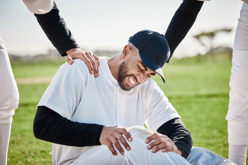 Baseball, team help and man with injury on field after accident, fall or workout in match. Sports, training and male player with fibromyalgia, inflammation pain or broken knee with friends helping. Bad player stock images, royalty-free photos and pictures