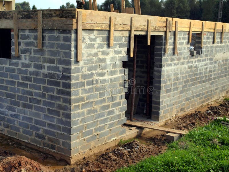 Basement wall of concrete blocks on the ground clay