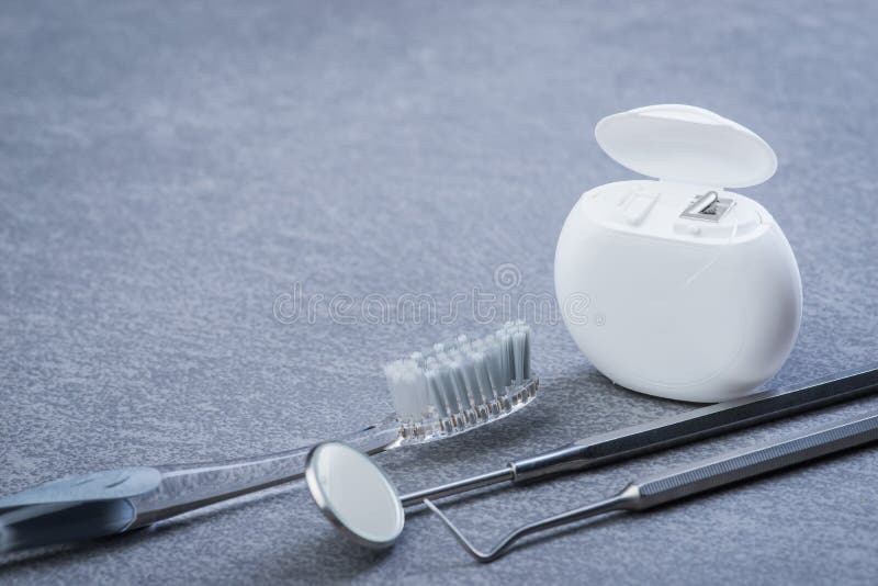 Basic Dental Tools, Floss and Brush on Grey Surface Stock Photo Image