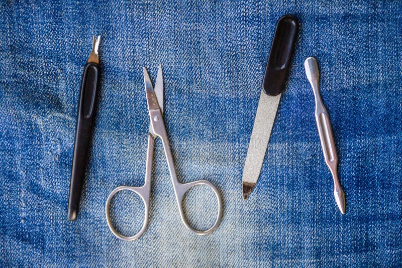 Basic set of manicure tools on jeans background royalty free stock photos