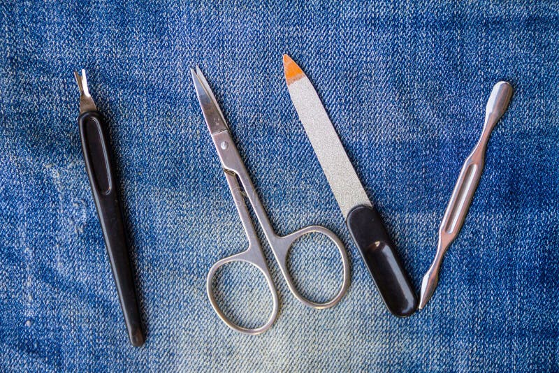 Basic set of manicure tools on jeans background stock image