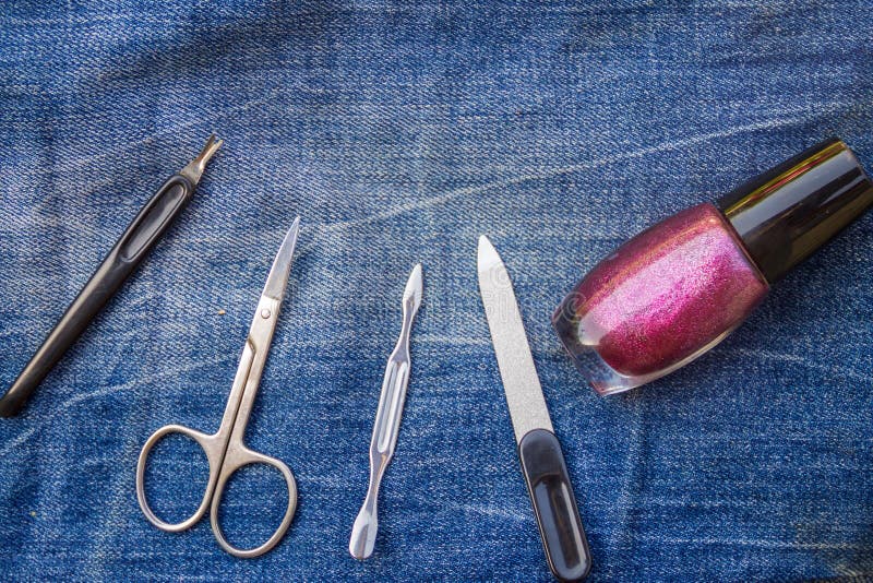Basic set of manicure tools on jeans background stock photos