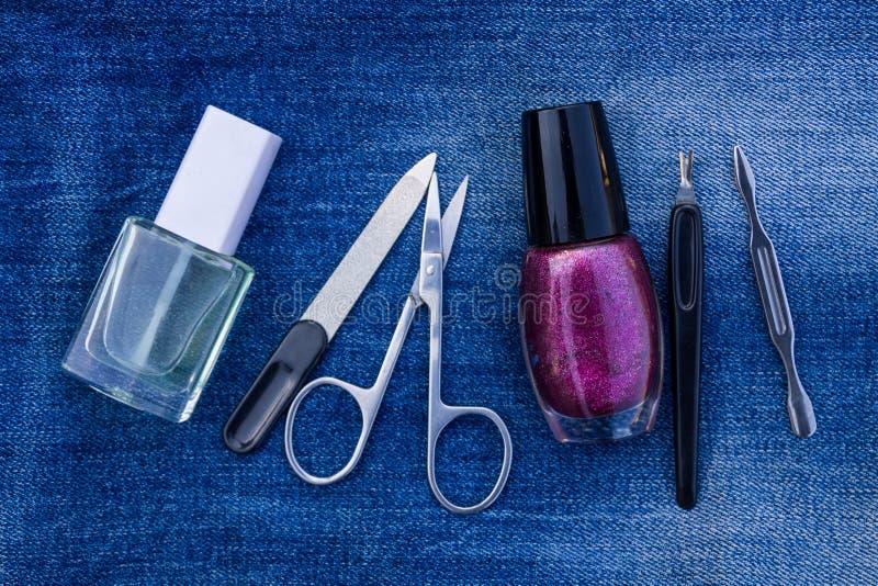 Basic set of manicure tools on jeans background stock image