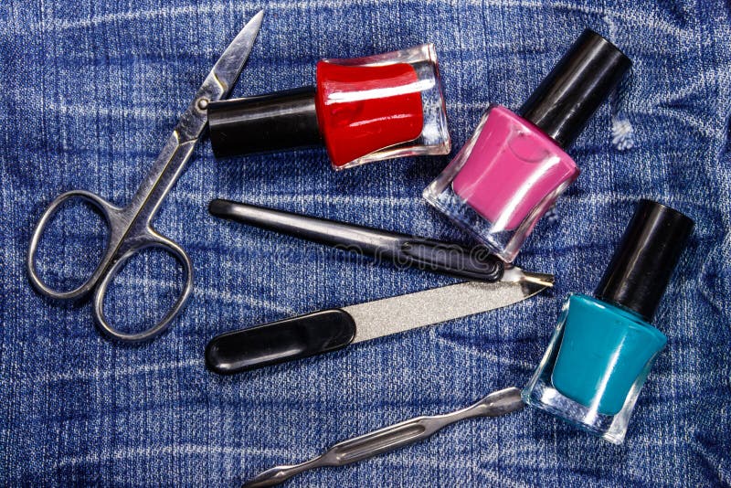 Basic set of manicure tools on jeans background stock image