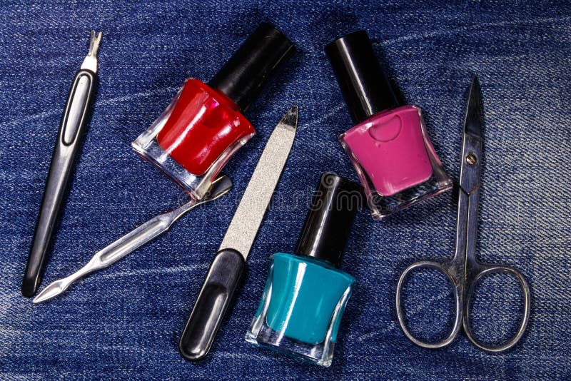 Basic set of manicure tools on jeans background stock photography