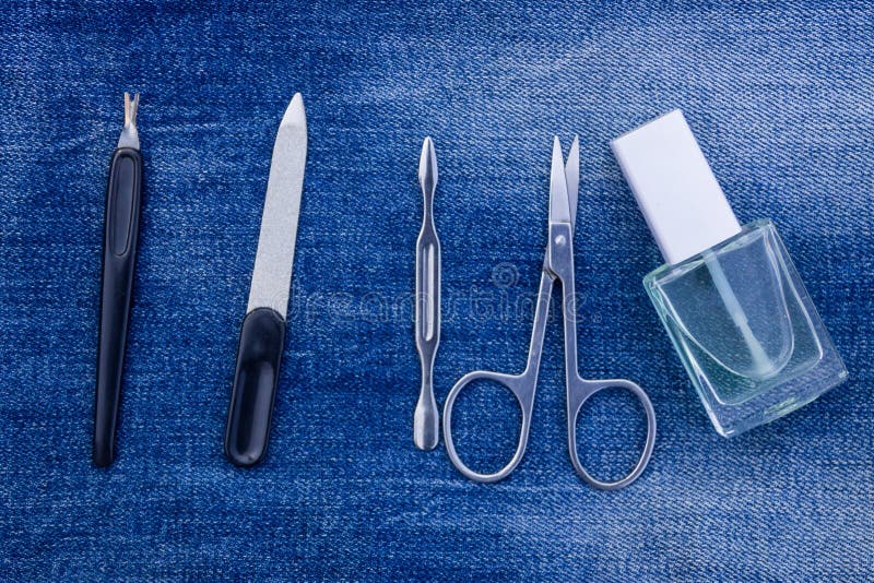 Basic set of manicure tools on jeans background stock photos