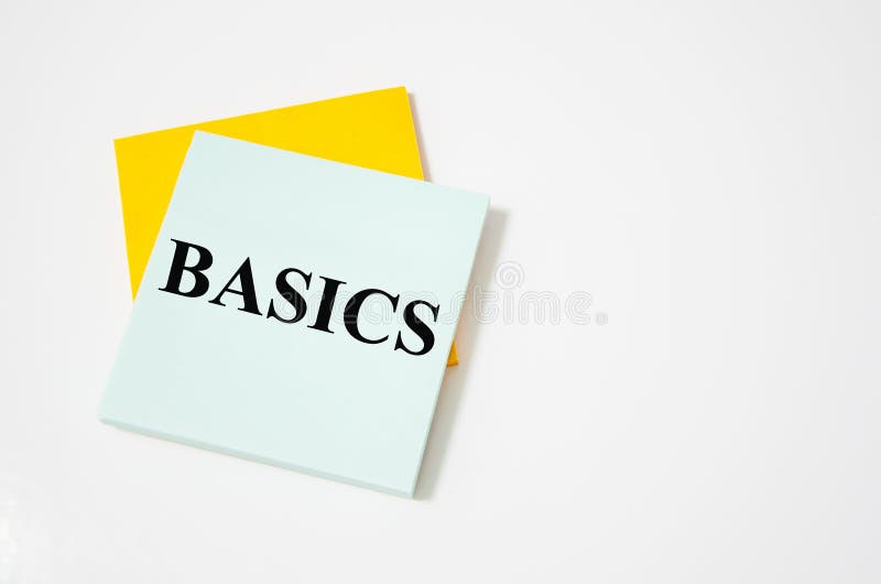 BASIC text written on a white notepad with colored pencils and a yellow background. word royalty free stock image