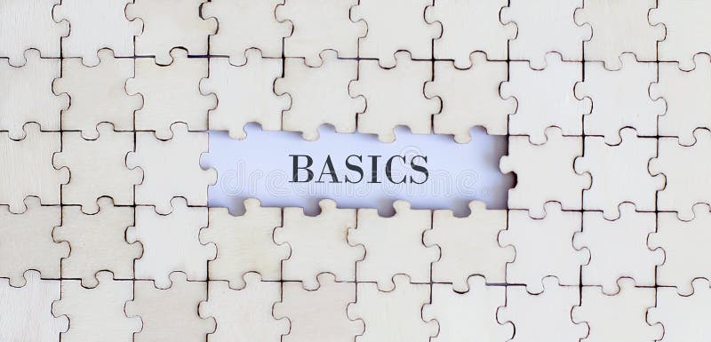BASICS. Business concept. White puzzle pieces with different phrases on the white background, top view
