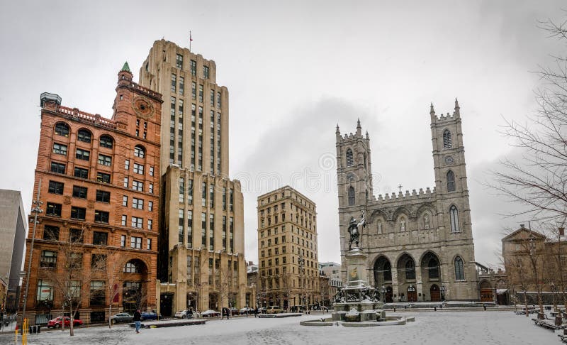 Basilica of Notre-Dame of Montreal and Place d`Armes on snow - Montreal, Quebec, Canada