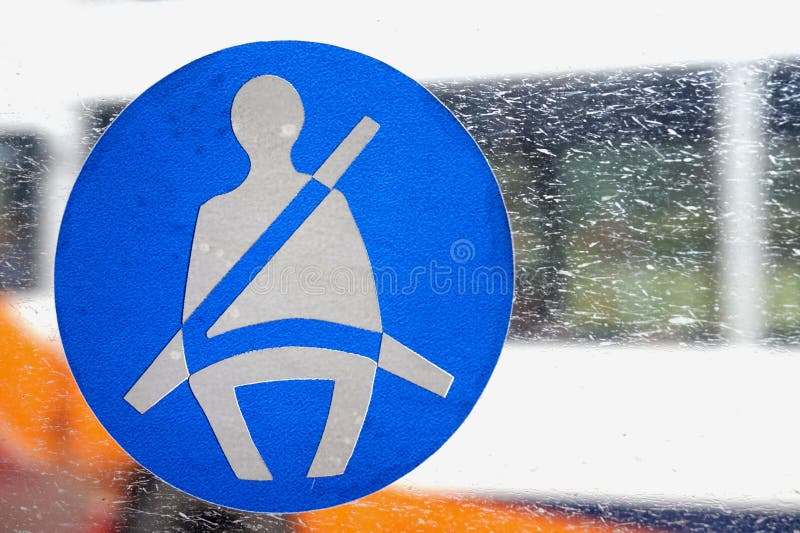 Basingstoke, UK - Jan 09 2016: Fasten seatbelt sign on the window of a public transport bus royalty free stock photos Basingstoke, UK - Jan 09 2016: Fasten seatbelt sign on the window of a public transport bus royalty free stock photos