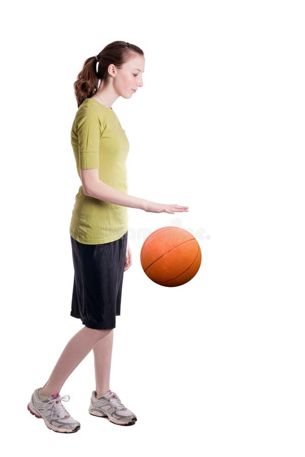 Isolated teen age girl dribbling a basketball. Isolated teen age girl dribbling a basketball