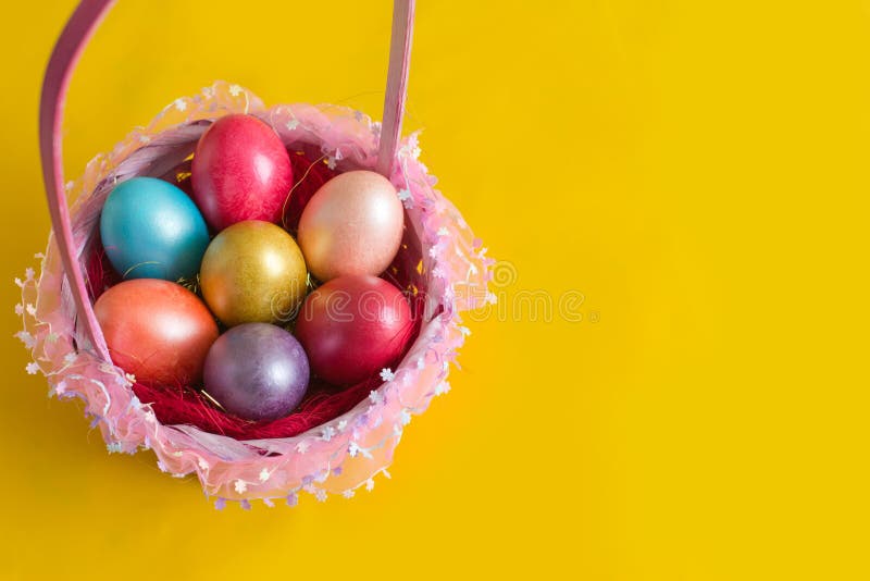 Preparing for Easter. Photo of a set of traditional colorful eggs in beautiful basket. Preparing for Easter. Photo of a set of traditional colorful eggs in beautiful basket.