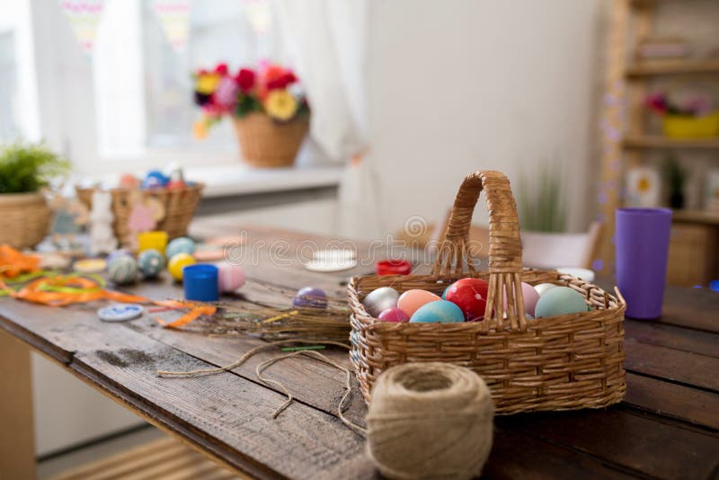 Background image of wicker basket with Easter eggs on wooden table in crafting workshop set for set for making decorations, copy space. Background image of wicker basket with Easter eggs on wooden table in crafting workshop set for set for making decorations, copy space