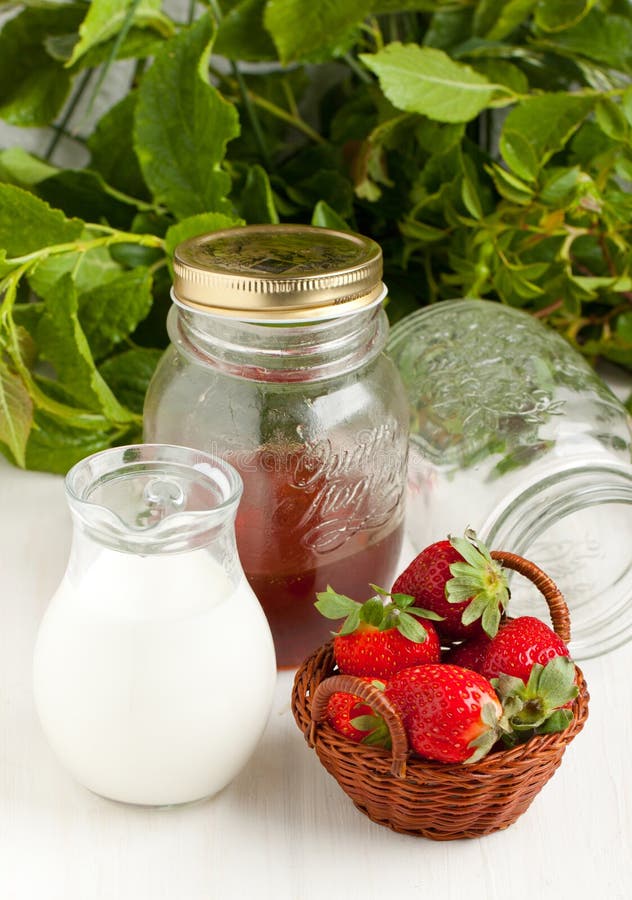 Basket of fresh strawberries with milk and honey