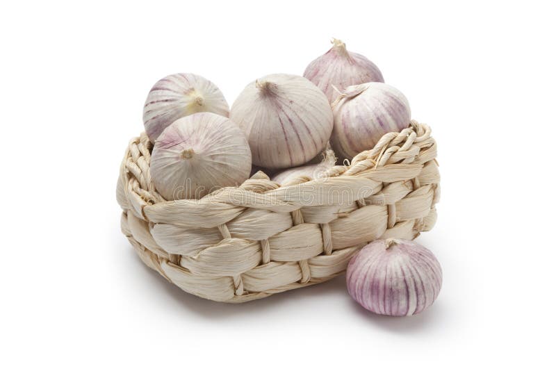 Basket with whole fresh single clove garlic