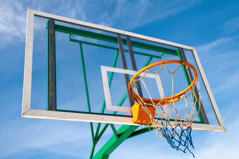 Basketball hoop in the park against the blue sky