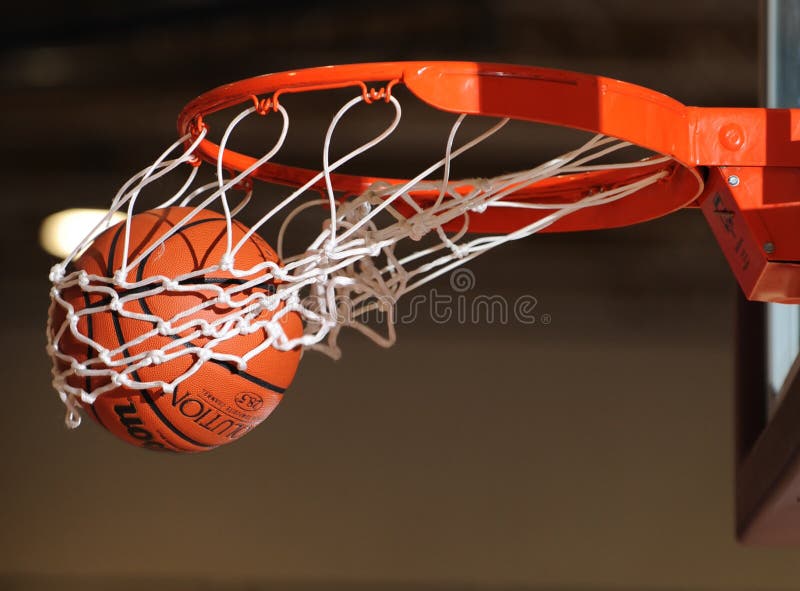Basketball ball going through the net.
