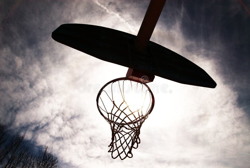 Basketball hoop silhouetted.