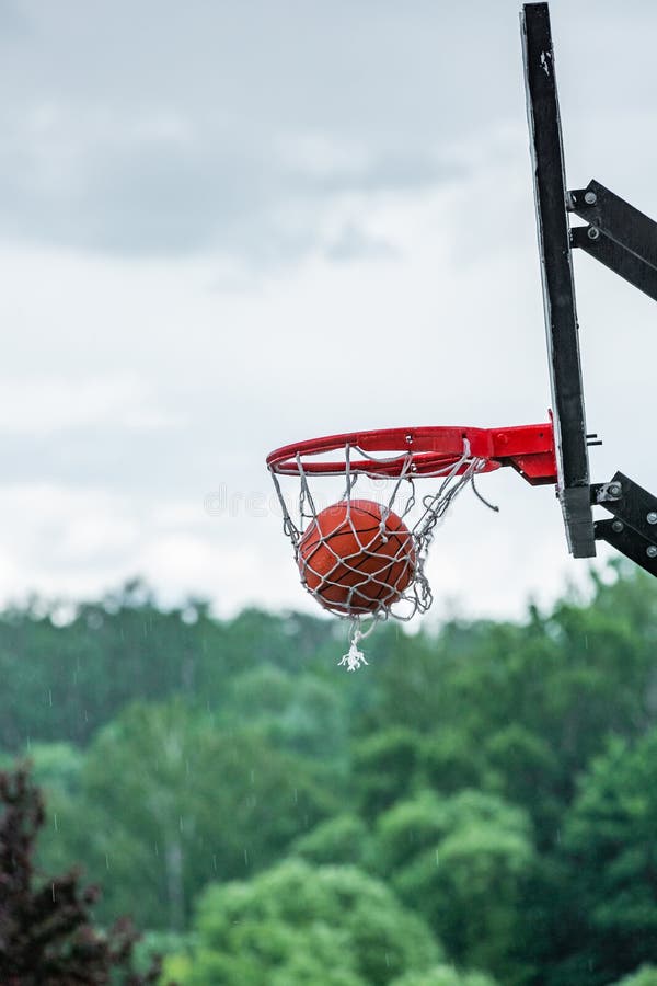 Basketball in Hoop on Street Background. Street Basketball Stock Image