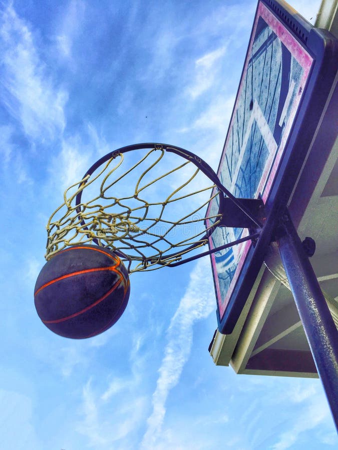 Basketball hoop with ball making it through the net, Nice for concepts of success, reaching goals, etc. Basketball hoop with ball making it through the net, Nice for concepts of success, reaching goals, etc.