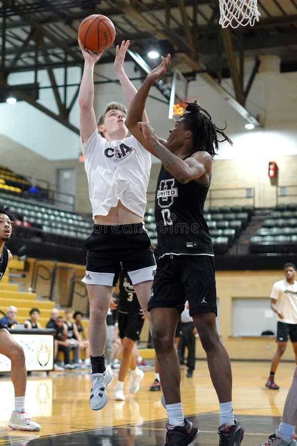 Basketball Player Shooting the Ball into the Hoop Editorial Stock Image